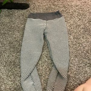 Gray and white netted leggings with ruching on the back.